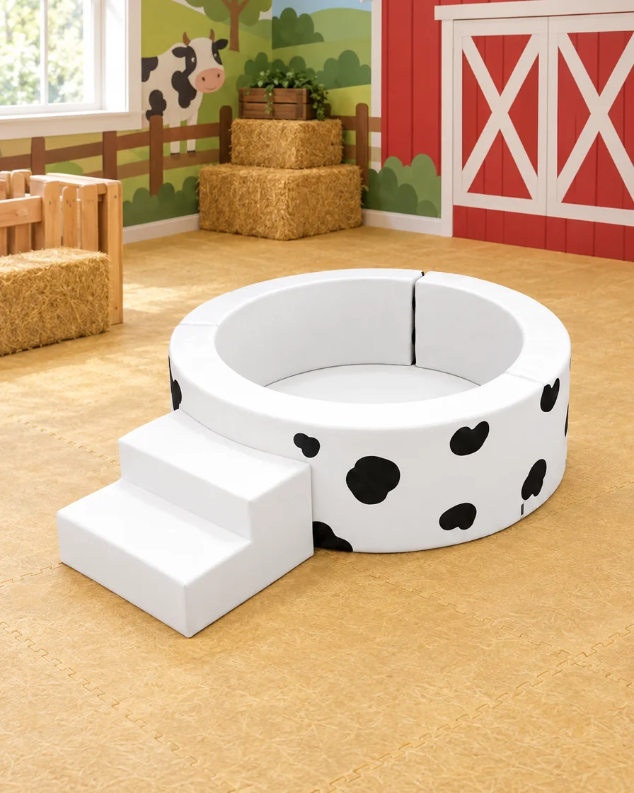 PlayCurator Round Soft Play Ball Pit with Step — Cow Print 1 Cow Print round Soft Play Ball Pit with Step in a farm theme corner indoor playground